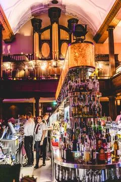 Bar interior in Dublin showcasing elegant architecture and lively atmospher.. 스톡 사진