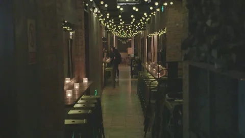 Bar Interior with People Walking Under String Lights in Beijing, China at Night Stock Footage 345755403
