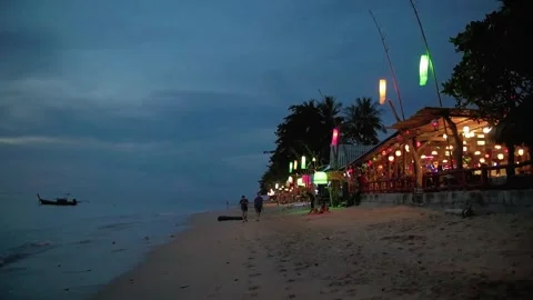 Bar with lanterns on a beach in thailand at night 스톡 동영상 247453002