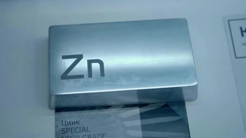 A bar made of chemically pure zinc is presented at the exhibition Stock Footage 340633030