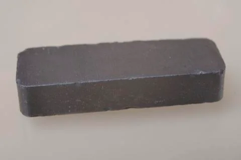 Bar magnet on beige background. Stock Photos