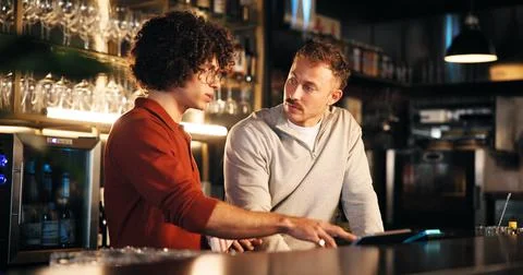 Bar, manager and training with tech for order, teamwork and explaining system to Stock Photos
