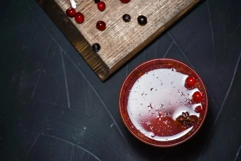 Bar menu hot fruit tea with orange slices, cinnamon and berries on a stone bo Stock Photos