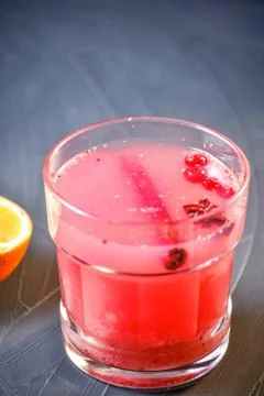 Bar menu hot fruit tea with orange slices, cinnamon and berries on a stone bo Stock Photos