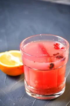 Bar menu hot fruit tea with orange slices, cinnamon and berries on a stone bo Stock Photos