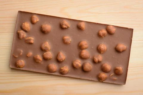 Bar of milk chocolate with nuts Stock Photos