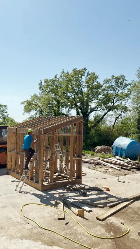 Bar, Montenegro, 2 May 2026, Man builder assembling frame construction house Stock Footage 334784902