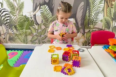 Bar, Montenegro, 7 Jule 2025, Cute girl child toddler playing with constructi 스톡 사진