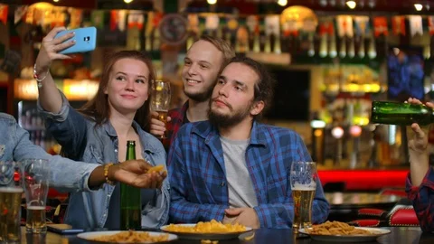 In the Bar or Restaurant Hispanic man Takes Selfie of Herself and Her Best Stock Footage 114899669