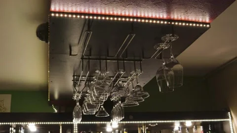 Bar rack glasses hang on the ceiling decor of the cafe 스톡 동영상 142410843
