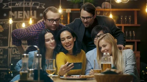 In the Bar/ Restaurant Hispanic Woman Takes Selfie of Herself and Her Friends Stock Footage