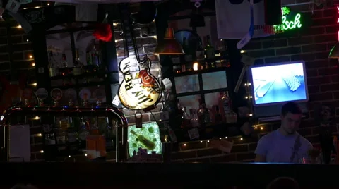 Bar in the semi-darkness and the bartender throwing bottles 스톡 동영상 48759145