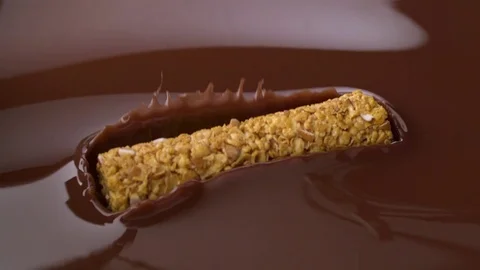  Bar from serial go into chocolate bath Stock-Footage 81795929