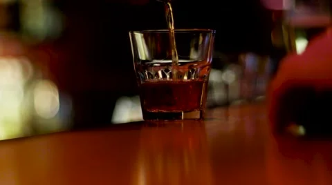 Bar staff pouring scotch whiskey into a glass of alcoholic visitor. Stock Footage