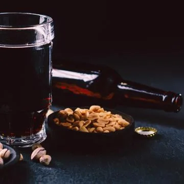 Bar table. dark craft stout beer and snacks set Stock Photos
