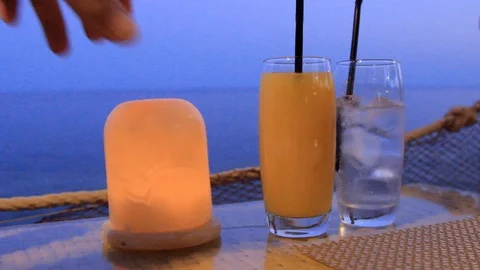 In a bar on a table on the shore against the blue sea stand two glasses with coc Stock Footage 115664207