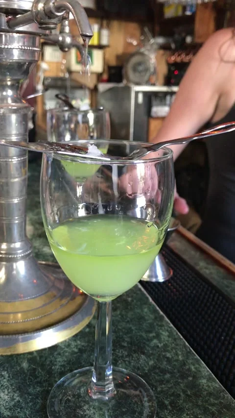 Bar tender working on an absinthe drink in New Orleans LA Stock Footage 233829460
