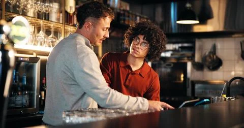 Bar, waiter and teamwork with tech for order, manager and training of employee Stock Photos