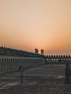 The Bara Imambara Historic courtyard at sunset with silhouetted people Stock Photos
