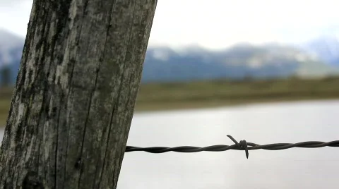 Barb wire rack focus to mountains Stock Footage 755030