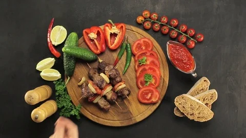 Barbecue and vegetables on a black table Top. Slide. Slow motion Stock Footage 81713205