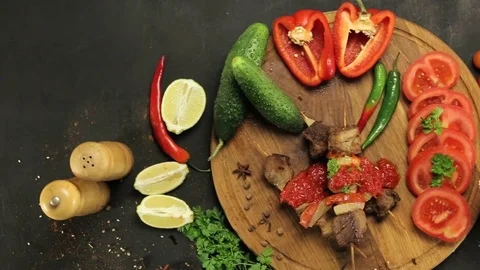 Barbecue and vegetables on a black table Top. Slide. Slow motion Stock Footage 81713242