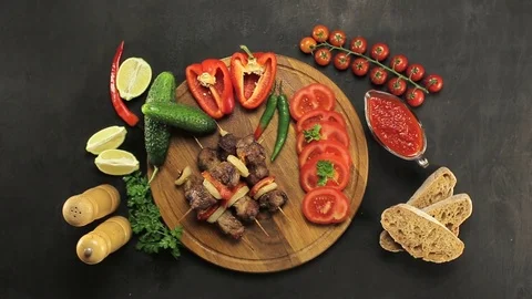 Barbecue and vegetables on a black table Top. Slide. Slow motion Stock Footage 81713245
