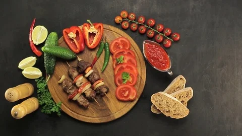 Barbecue and vegetables on a black table Top. Slide. Slow motion 스톡 동영상 81713249