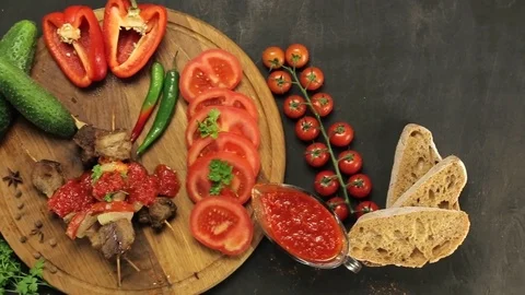 Barbecue and vegetables on a black table Top. Slide. Slow motion Stock Footage 81713268