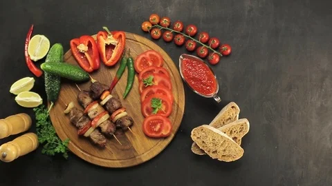 Barbecue and vegetables on a black table Top. Slide. Slow motion Stock Footage 81713273