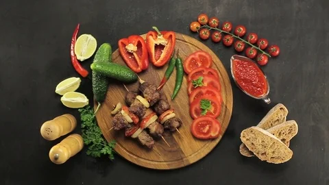 Barbecue and vegetables on a black table Top. Slide. Slow motion Stock Footage 81713306
