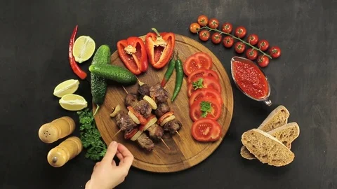 Barbecue and vegetables on a black table Top. Slide. Slow motion Stock Footage 81713324