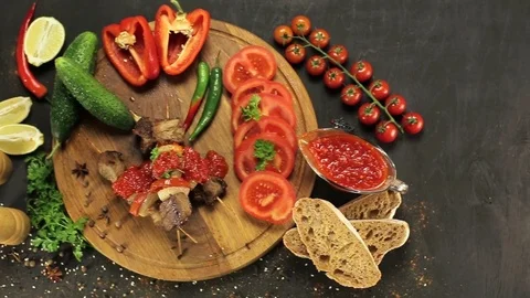 Barbecue and vegetables on a black table Top. Slide. Slow motion Stock Footage 81713348