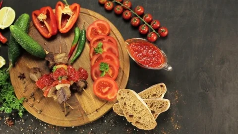 Barbecue and vegetables on a black table Top. Slide. Slow motion Stock Footage 81713356