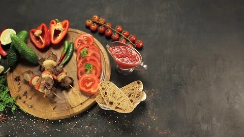 Barbecue and vegetables on a black table Top. Slide. Slow motion Stock Footage 81713364