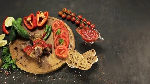 Barbecue and vegetables on a black table Top. Slide. Slow motion Stock Footage 81713367