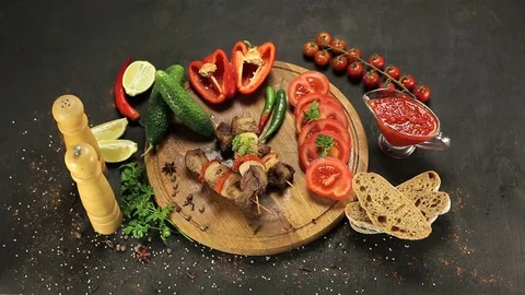 Barbecue and vegetables on a black table Top. Slide. Slow motion Stock Footage 81713395