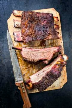 Barbecue chuck beef ribs with hot rub as top view sliced on a wooden cutting  Stock Photos