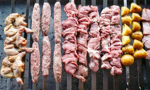 Barbecue from different types of meat in the restaurant on the background of the Stock Photos