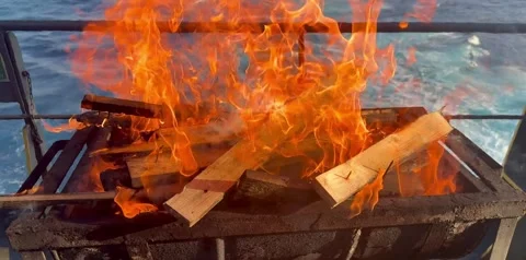 Barbecue Fire Being Lit on Ship Deck for Outdoor Cooking Stock Footage 336590540