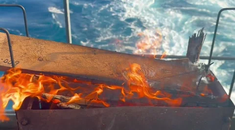 Barbecue Fire Being Lit on Ship Deck for Outdoor Cooking Stock Footage 336590570