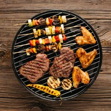 Barbecue garden grill with beef steaks, close-up. Stock Photos