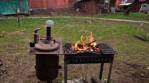 Barbecue grill on background, slow flame of burning fire, outdoor cooking Stock Footage 231749486