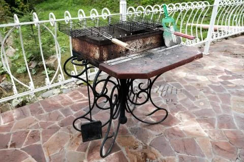 Barbecue grill in the backyard outside. Empty dirty kitchen equipment Stock Photos