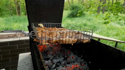 Barbecue grill. Close-up. Sometimes a man turns the meat on the grill. The conce Stock Footage 110575475