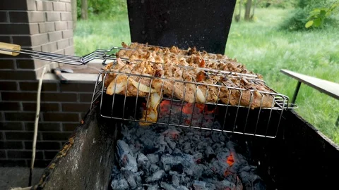 Barbecue grill. Close-up. Sometimes a man turns the meat on the grill. The conce Stock Footage 110575717