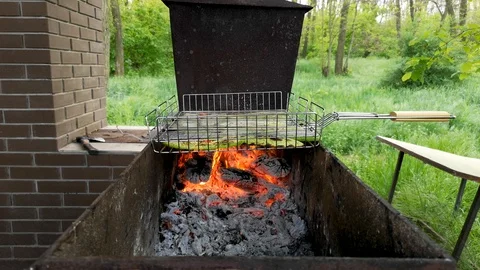 Barbecue grill. Close-up. Sometimes a man turns the meat on the grill. The conce Stock Footage 110575924