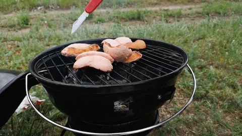Barbecue grill. Close-up. Sometimes a man turns the meat on the grill. The conce Stock Footage 111021809