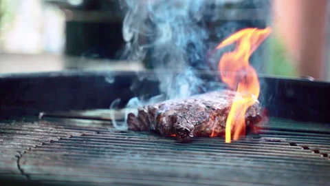 Barbecue grill concept, close-up of roasting juicy meat steak with herbs and Stock-Footage 132101204