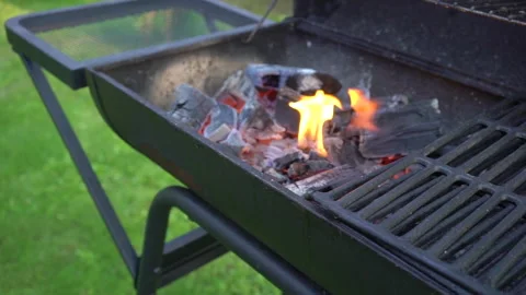 Barbecue grill with fire and glowing coals, summer picnic time, bbq grill in Stock Footage 132826624